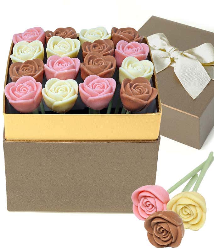 Valentine’s Day chocolate rose gift box featuring red and milk chocolate rose-shaped candies arranged in a gold-trimmed box, with a ribboned gift lid and two chocolate rose pops displayed in front.