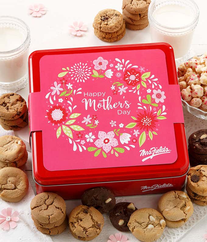 A colorful tin filled with Mrs. Fields cookies and frosted popcorn