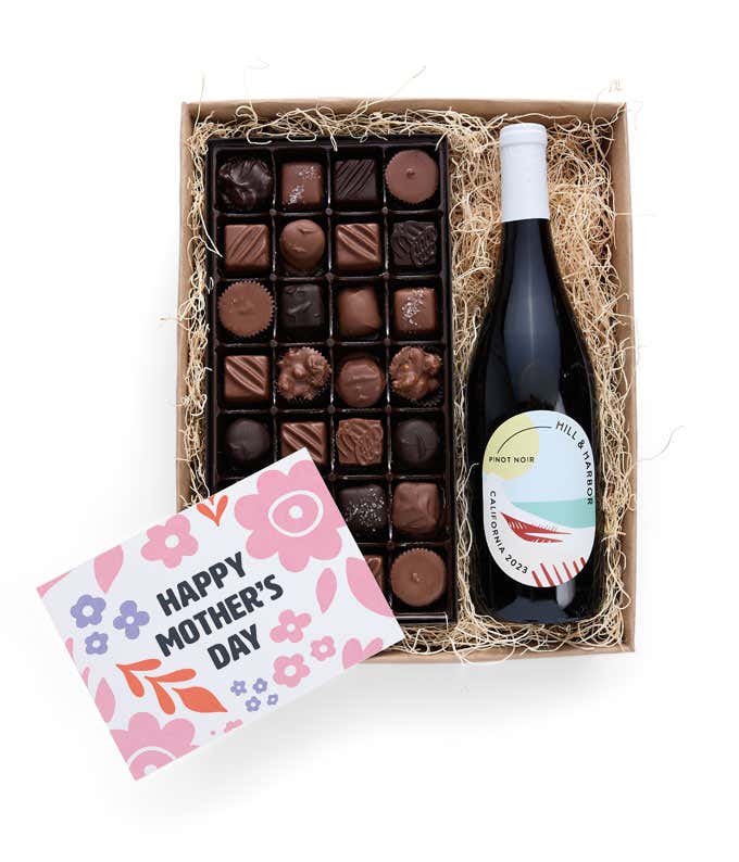 A gift box with Hill & Harbor Pinot Noir and a 1 lb. box of assorted artisan chocolates with a 'Happy Mother's Day' card placed on top.
