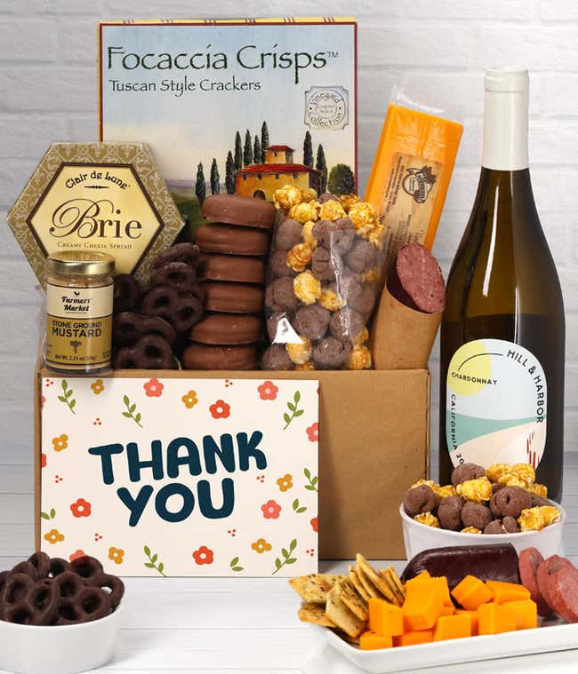 A gift set featuring a bottle of California Chardonnay, focaccia crisps, two cheeses, mustard, summer sausage, caramel popcorn, chocolate pretzels, six chocolate-covered Oreos and a Thank You card to complete the gourmet experience.