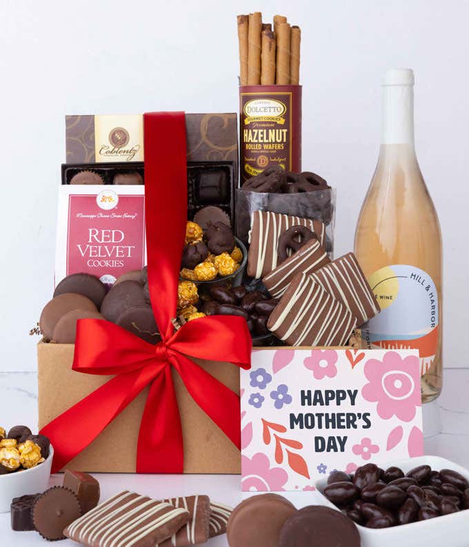 A bottle of Hill & Harbor Rosé sits beside chocolate-covered pretzels, mini chocolate chip cookies, caramel popcorn, assorted chocolates, mini buckeyes, chocolate covered Oreos, and a Happy Mother's Day card.