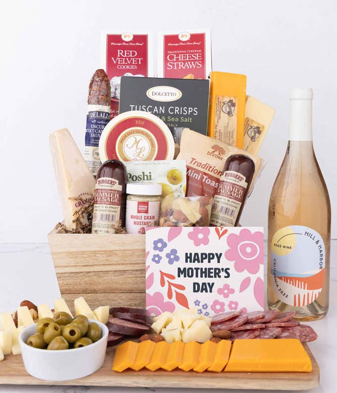 Mother’s Day charcuterie crate featuring Hill & Harbor Rosé with artisan sausage, cheeses, olives, Tuscan crisps, mustard, cookies, and savory snacks, styled with sliced meats, cheeses, and a floral card.