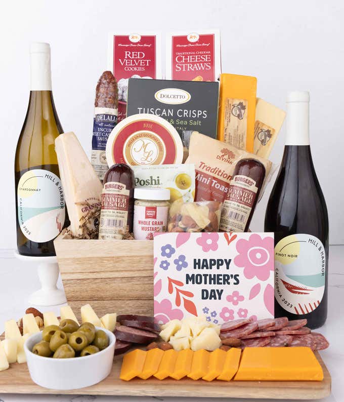 Mother’s Day charcuterie collection with Hill & Harbor Pinot Noir and Chardonnay, artisan salami and sausages, cheeses, olives, crisps, cookies, and savory snacks, displayed with sliced meats, cheeses, and floral card.
