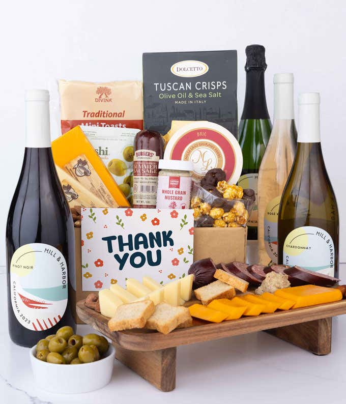 A wine and cheese gift set featuring 4 - bottles of Hill & Harbor wine - sparkling, white, rosé and red. Includes a variety of gourmet cheeses, crackers, olives, summer sausage, almonds, and condiments finished with a Thank You card.
