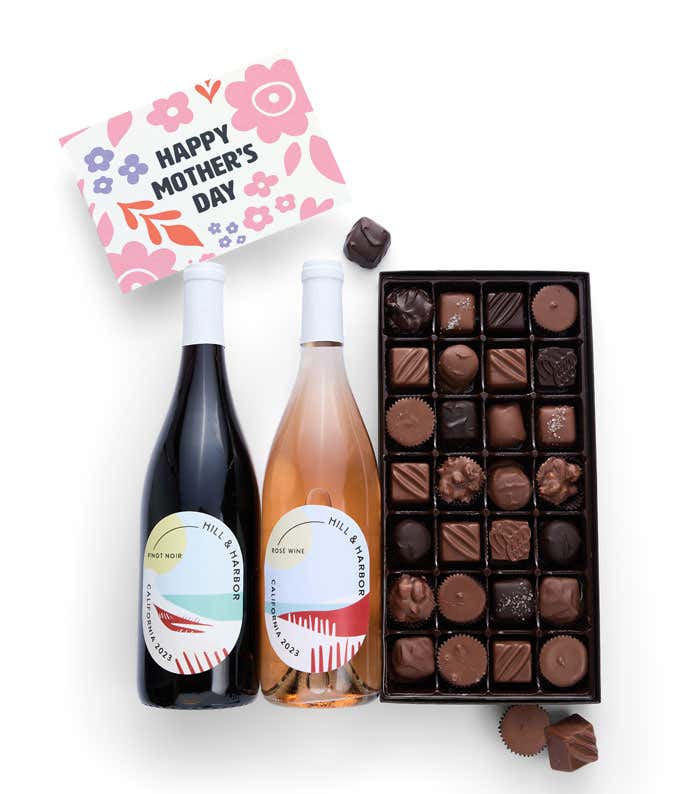 Bottles of Hill & Harbor Pinot Noir and Rosé wine sit alongside a 1 lb. box of assorted chocolates and a 'Happy Mother's Day' card.